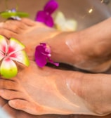 person's feet with flowers