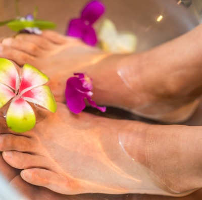 person's feet with flowers